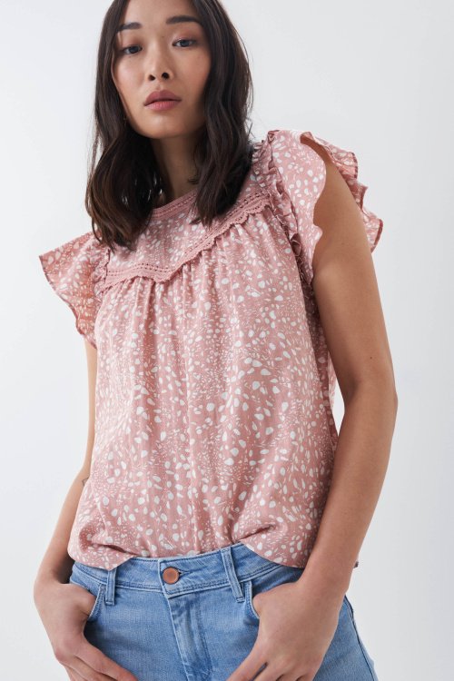 Top with ruffles and lace at neckline