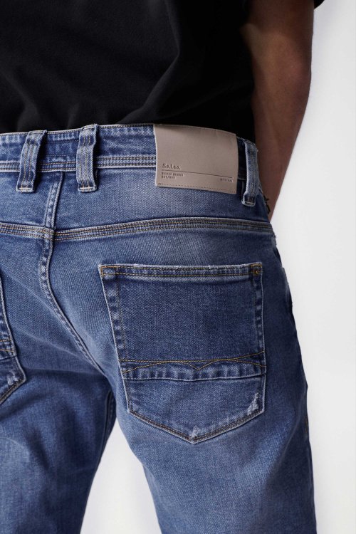 Medium wash denim jeans with rips